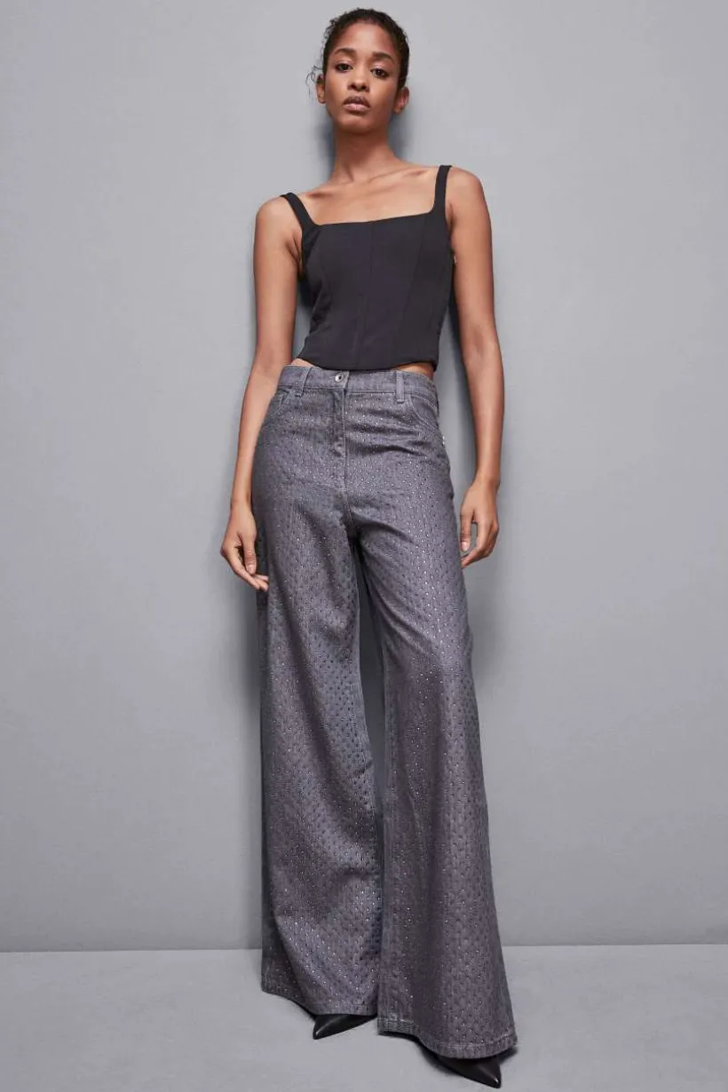 Jeans grigio vita bassa wide leg con strass