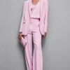 Pantaloni con pieghe in tessuto stretch