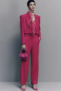 Pantaloni con pieghe in tessuto stretch
