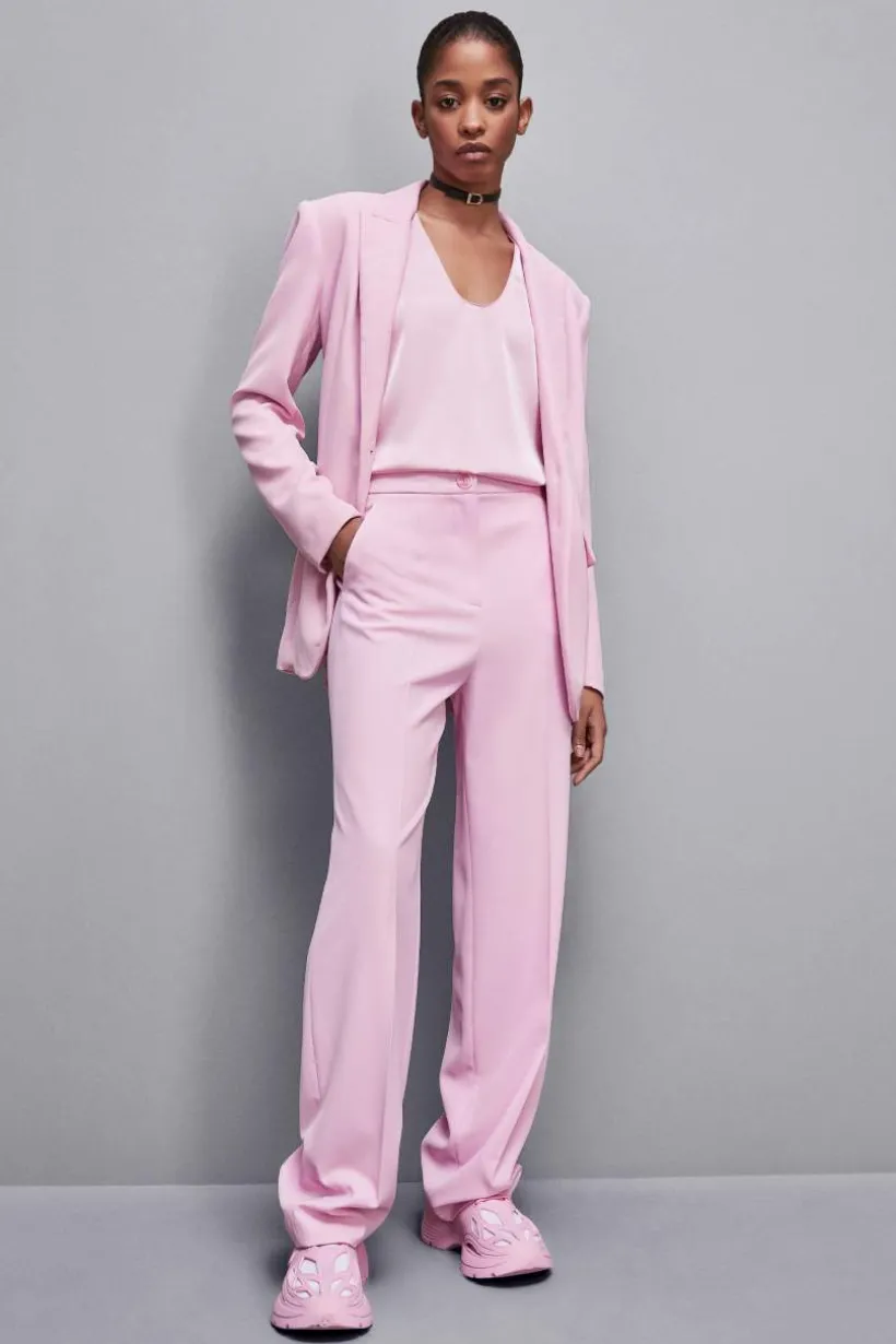 Pantaloni con pieghe in tessuto stretch