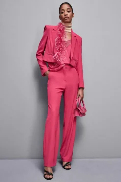 Pantaloni con pieghe in tessuto stretch